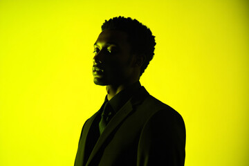 Obraz premium Mens Black Suit with Neon Yellow Highlights Sophisticated Fashion Portrait, Stylish Background