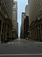 Downtown City Street at Dusk with Glowing Building Lights and Car Headlights