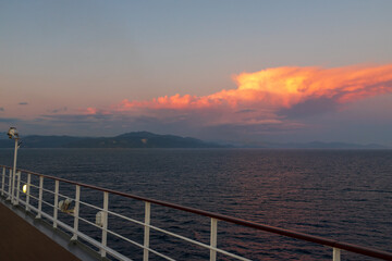 Greek sunsets over the Aegean sea during summer from the open deck of a cruise ship