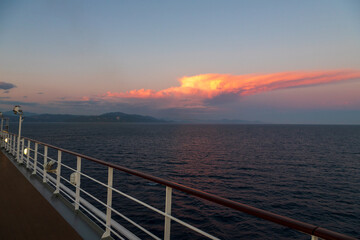 Greek sunsets over the Aegean sea during summer from the open deck of a cruise ship