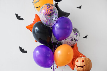 Colorful Halloween balloons with bats and pumpkin on white background