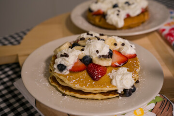 Pancakes with whip cream and strawberries