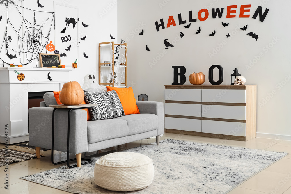 Wall mural interior of light living room decorated for halloween with sofa and drawers