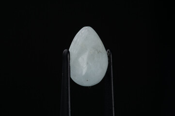 Exquisite Close-Up of a Teardrop White Gemstone on a Dark Background