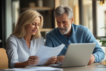 Two joyful business partners collaborate on financial report in corporate office meeting