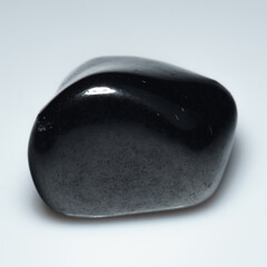 Elegantly Polished Shungite Gemstone on Pristine White Background