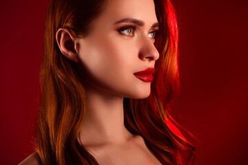 Fototapeta premium Photo of lovely attractive lady look empty space confident model shoulders off isolated on red color background