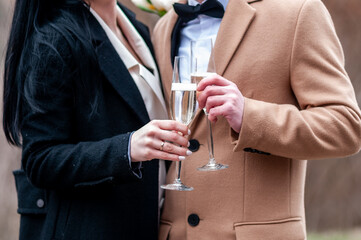 Elegant Couple Toasting with Champagne in Stylish Attire