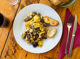 Delicious omelette with with mushrooms and blood sausage served for breakfast..