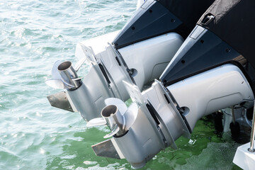 Outboard engine propeller on motorboat closeup on sea waters background