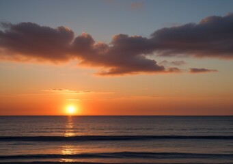 Fototapeta premium Sunset Over Calm Ocean Waves