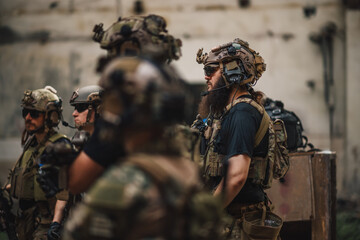 Group of fully armed brave soldiers standing in demolished ruins.