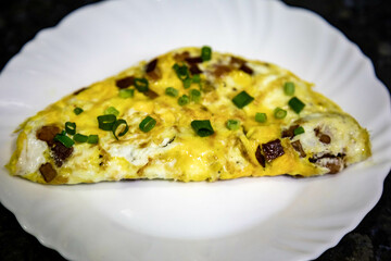Traditional omelette with bacon and chives, real food, strong and nutritious protein