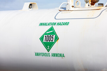Anhydrous ammonia tank in farm field. Agriculture fertilizer application, costs and farmer safety concept.