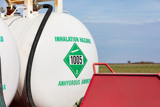 Anhydrous ammonia tank in farm field. Agriculture fertilizer application, costs and farmer safety concept.