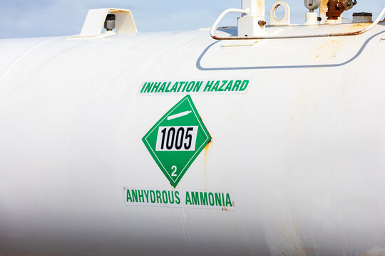 Anhydrous ammonia tank in farm field. Agriculture fertilizer application, costs and farmer safety concept.