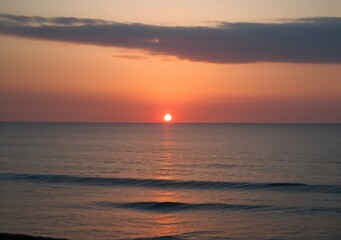 Fototapeta premium Sunset Over Calm Ocean Waves