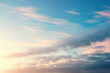 Sunset sky background in vivid tones, dramatic panoramic sunset sky with fluffy clouds, sunset sky landscape