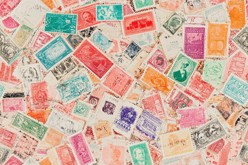 Seamless pattern of vintage postage stamps from around the world, slightly overlapping