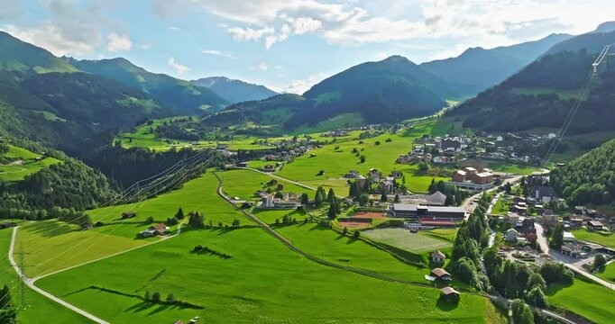 Aerial view of the beautiful Swiss nature and village in Switzerland. Idyllic mountain landscape in Switzerland, aerial Swiss rural landscape in the morning, alpine village of Disentis in Swiss Alps