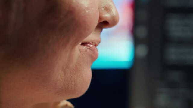 Extreme closer up shot of happy computer engineer satisfied after futureproofing company network from system failures. Smiling IT worker pleased after managing to increase data security, camera A
