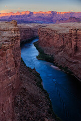 A motor boat travels upstream along the Colorado River as it flows through Marble Canyon near Page, Arizona.
