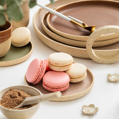 Pink and white macaron on a diner table, elegant and classic tableware. Afternoon tea