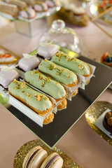 delicious dessert eclairs, Sweet cupcakes, Colorful macaroons, Bakery sweet, banquet table, holiday. Birthday, wedding, strawberry cake, donuts, tart, chocolate cake slice