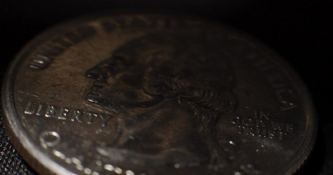 Close-Up of US Quarter with Passing Shadows