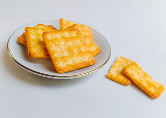 A pile of square sweet crackers served on the plate