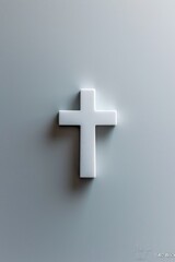Obraz premium White Christian cross on textured grey wall highlighting simplicity and symbolism of faith.