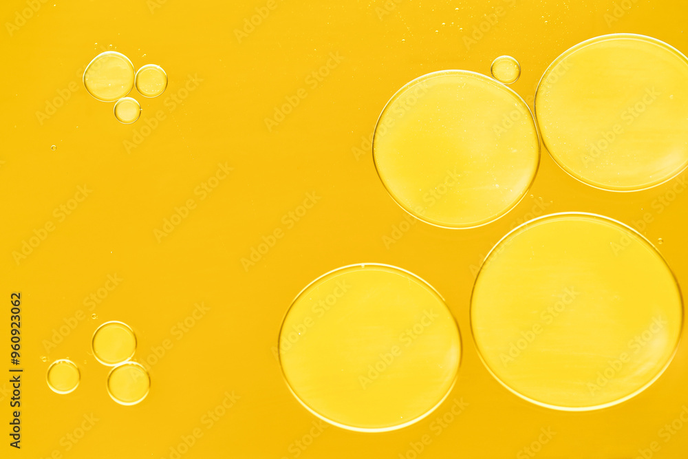 Canvas Prints Sample of cosmetic oil on dark yellow background, macro view