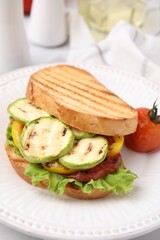 Tasty sandwich with grilled vegetables on table, closeup