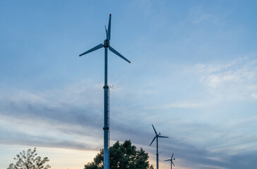 Wind turbine blades against a sunset sky