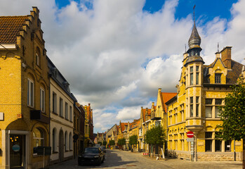 Obraz premium Picturesque view of Diksmuide street with typical residential buildings on sunny summer day, Belgium.