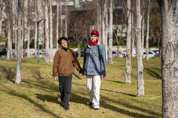 Fototapeta premium Young gay couple walking in a park