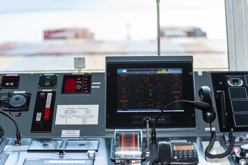 View of the control console on the navigational bridge of the cargo container ship. 
