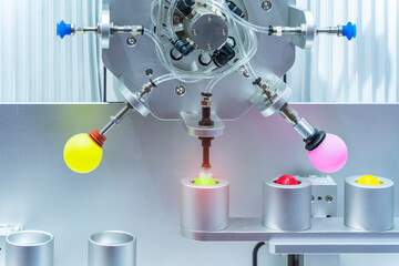 Robotic Arm use with vacuum system for holding colorful table tennis ball, Industrial 4.0 technology for modern factory management.