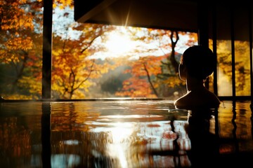 紅葉バックに温泉に入る女性のシルエット