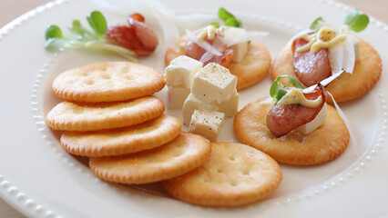 Appetizers plated cracker canapés  with sausage and cream cheese