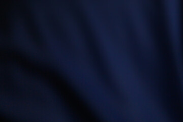 Abstract blurred background, dark blue, denim, berry tones. Dark and light, wavy, smooth, softness.