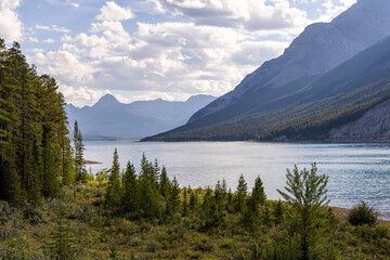 Scenic Mountain Lake View in Kananaskis, Alberta with Majestic Rocky Mountains and Blue Sky