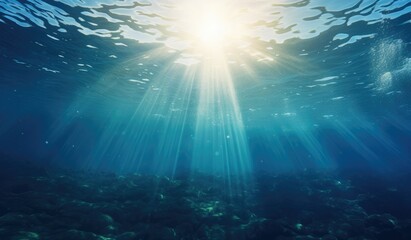 Naklejka premium Blue sea water crossed by sun rays, deep blue marine background