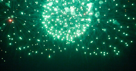 Blurred background Green Firework celebrate anniversary happy new year 2025, 4th of july holiday festival. Blurry Green firework night time celebrate national holiday. Countdown new year 2025 festive