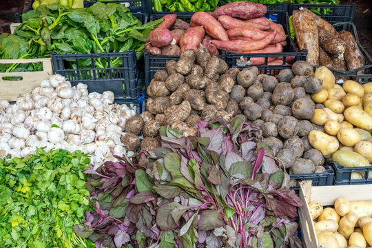 Potatoes, herbs and vegetables for sale at a market