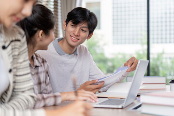 Students exchanging ideas during study with laptop