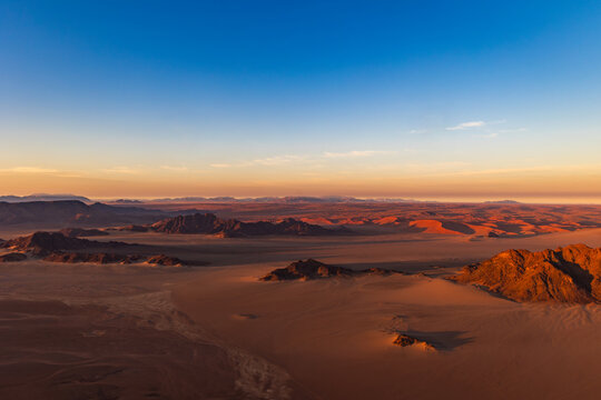 Namibia - July 11. 2024: Hot balloon flight over the Namibian red sand dunes in the morning. It is a tourist attaction in the desert