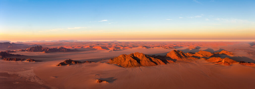 Panorama of Hot balloon flight over the Namibian red sand dunes in the morning. It is a tourist attaction in the desert