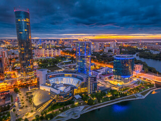 Naklejka premium Yekaterinburg city and pond aerial panoramic view at summer or early autumn night. Night city in the early autumn or summer.