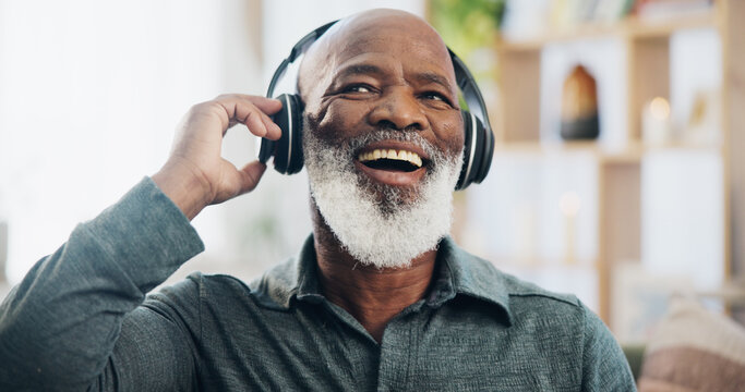 Senior man, headphones and retirement for music, relax and positive mood on weekend with radio in house. Black person, listening and happy in living room for podcast, streaming or jazz with happiness
